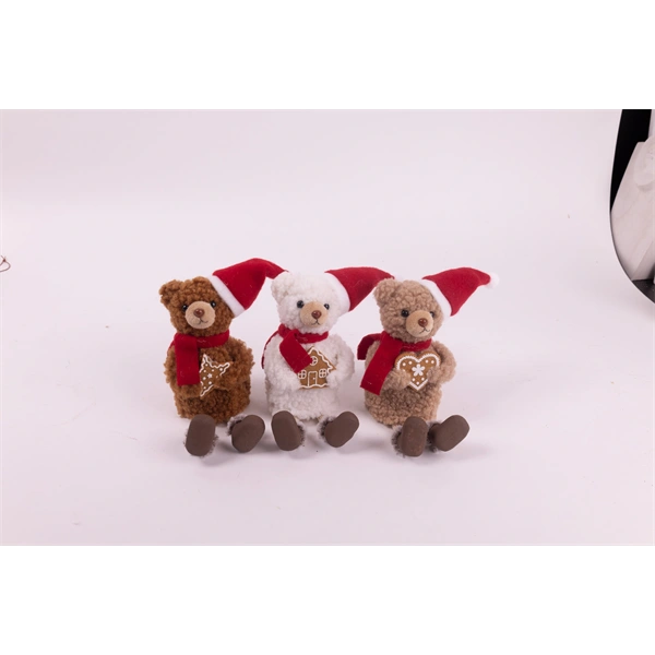 IRIS textil medve ülő, mikulás sapkában, mézeskalács süteménnyel a kézben,   18 cm